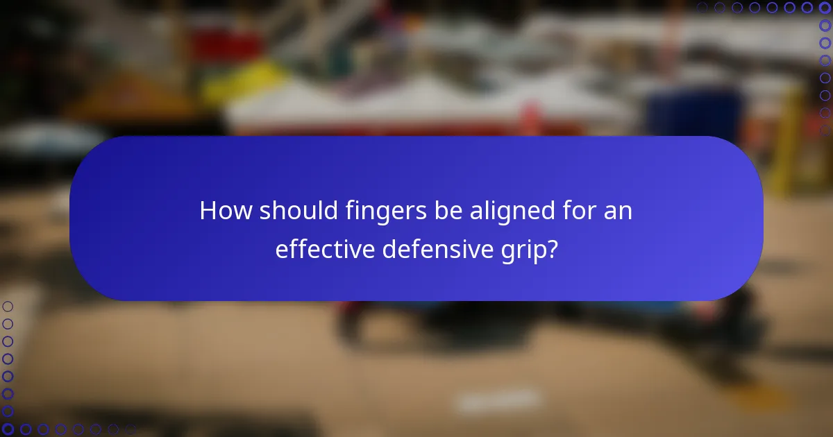 How should fingers be aligned for an effective defensive grip?